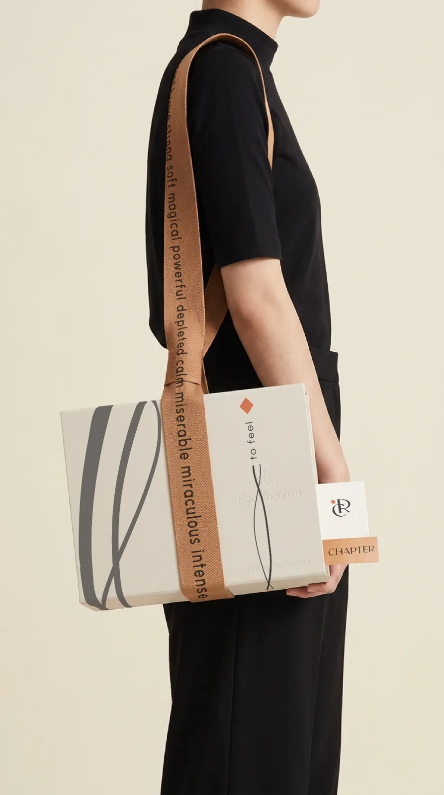 Chapter tote bag with printed strap carried by a model