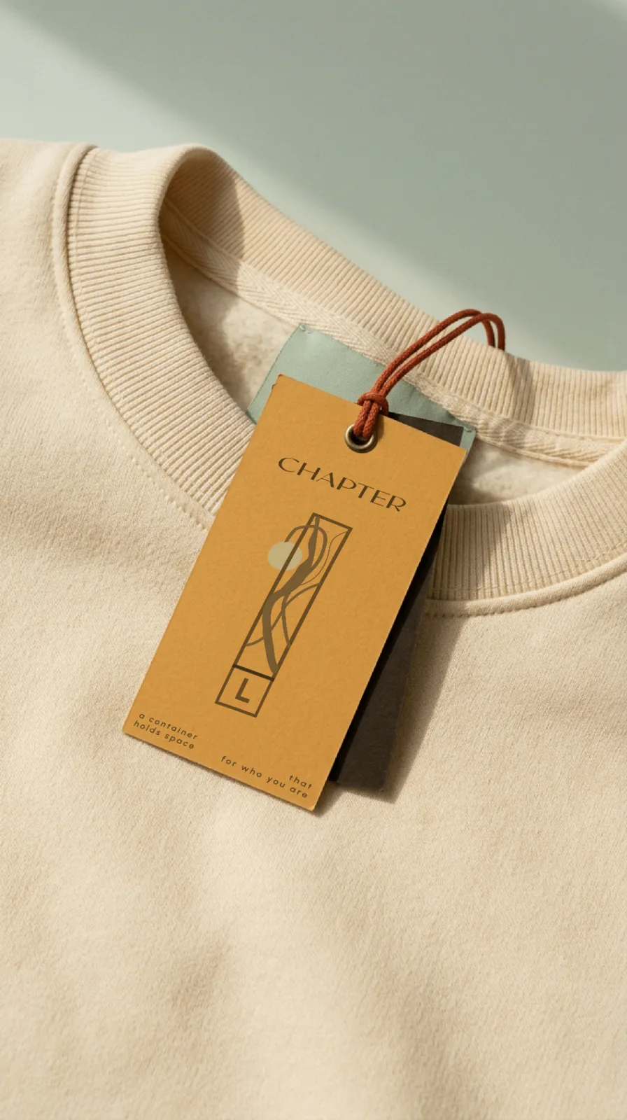 Chapter hang tag on a cream sweatshirt collar